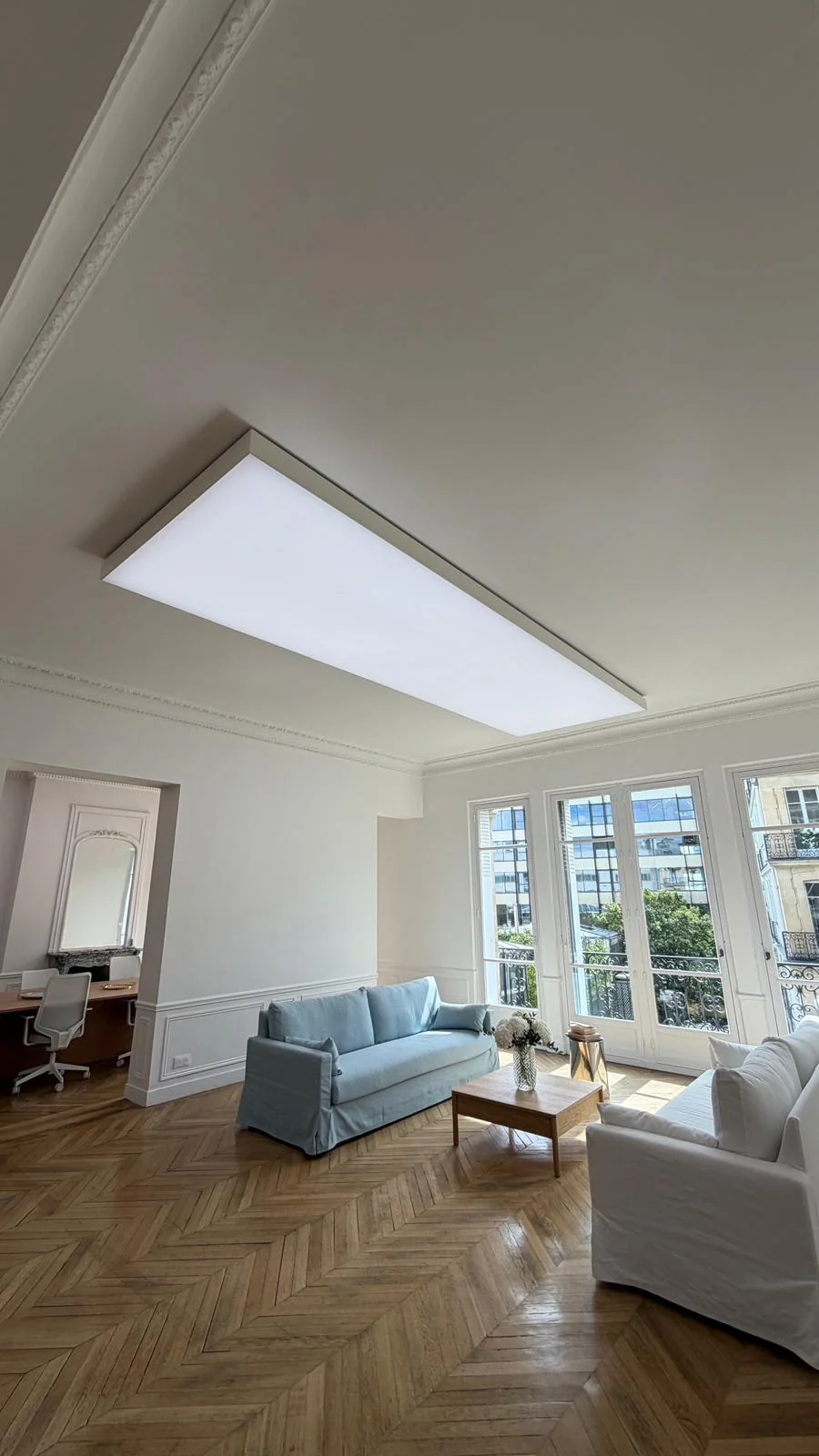 Illuminated StretchLume ceiling lightbox above the Paris office lounge